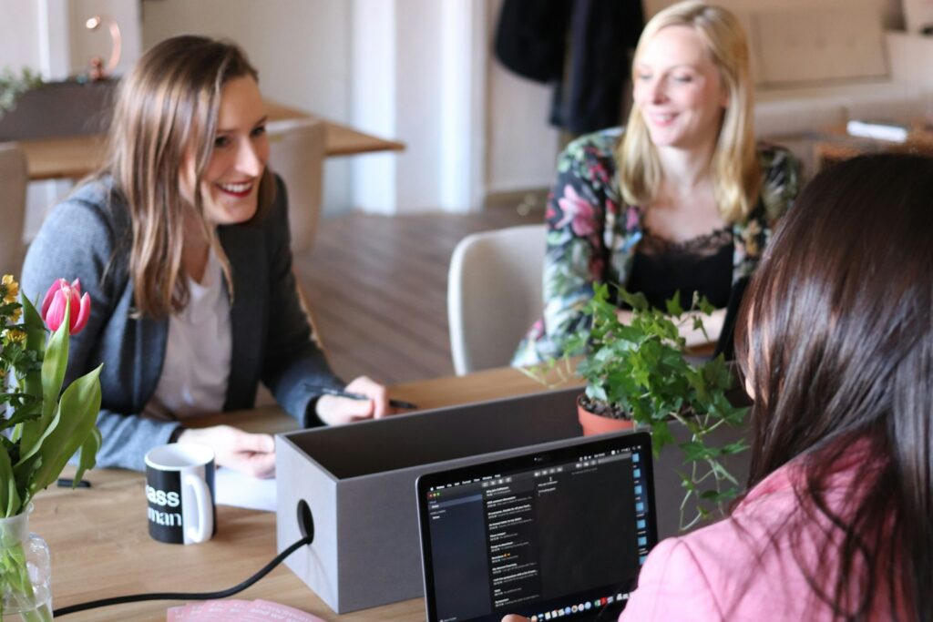 People seated around a wooden table during a meeting